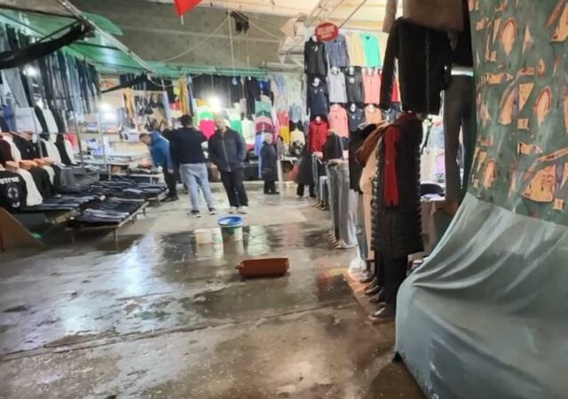 “Bashkia të ndërhyjë”/ Tregu industrial përmbytet nga reshjet, tregtarët kërkojnë ndihmë: Na dëmtohet malli